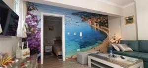 a living room with a wall mural of a beach at Casa-Naro in Mostar