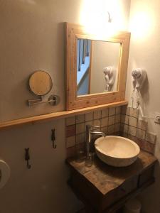 a bathroom with a sink and a mirror at Les Loft's de Mika in Briançon