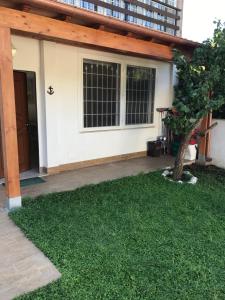 a house with a green lawn in front of it at Casaflavio in Torvaianica