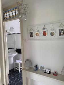 a bathroom with a sink and a counter with plates on the wall at Bed & Breakfast Jo Amsterdam in Amsterdam