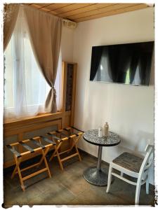 a room with a table and chairs and a window at Casa Mirada in Trin