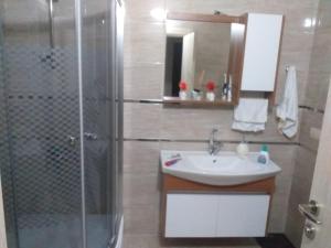 a bathroom with a shower and a sink at Trabzon Luxury Homes in Trabzon