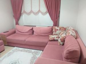 a pink couch in a living room with a window at Trabzon Luxury Homes in Trabzon