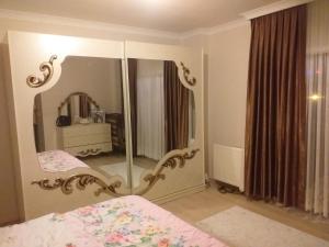a bedroom with a large mirror and a bed at Trabzon Luxury Homes in Trabzon