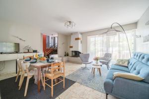 sala de estar con sofá azul y mesa en Cosy Home in South Alsace for work and leisure, en Pfastatt