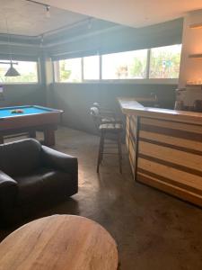 a living room with a pool table and a bar at Unique space in Gerakas - Cave in Athens