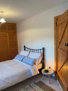 a bedroom with a bed and a wooden door at The Old Mill, Kilcorkey, Bellanagare, Castlerea, County Roscommon - West of Ireland in Bellanagare