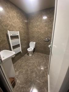 a bathroom with a toilet and a sink at Appartement Varketili in Tbilisi City
