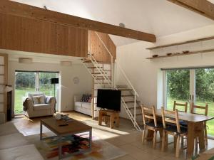 a living room with a staircase and a table and chairs at Gransäng Loft House in Nässjö