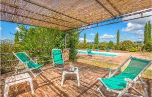a patio with two chairs and a table and a pool at Villa San Venanzo in Baccano