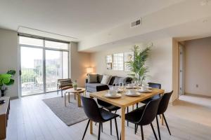 a living room with a table and chairs and a couch at Exclusive Condo With Stunning Views at Crystal City in Arlington