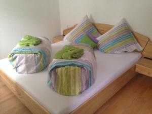 a bed with two blankets and pillows on it at Ferienwohnung Lechner in Karres