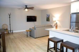 a kitchen and living room with a couch and a table at M&M's Maple Bay Mountain Guesthouse in Duncan