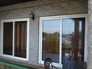 a balcony with a view of a table and chairs at CASA CAMPO DA FEIRA in Felgueiras