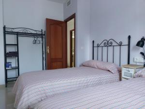 two beds sitting next to each other in a bedroom at Alojamiento en Bujalance in Bujalance