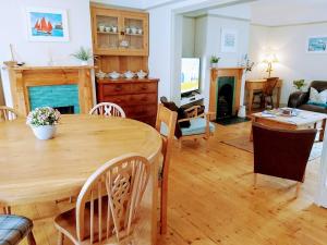 a living room with a wooden table and a dining room at The Nautical Nest in the heart of Dartmouth in Dartmouth