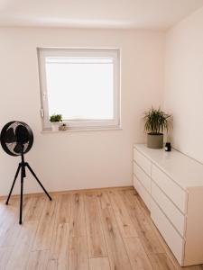 a room with a window and a dresser and a chair at Exklusiv 72qm FeWo im Herzen Detmolds, Terrasse und kostenloser Parkplatz in Detmold