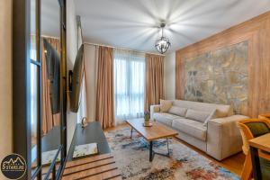 a living room with a couch and a table at 5 STARS - Luxury Premium WELLNESS RESORT Zlatibor in Zlatibor