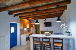 a kitchen with a white counter and a blue door at K vineyard house in Apróvaton