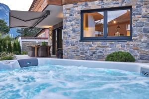a hot tub in the backyard of a house at Sunshine Apartment Spirit of Deer in Garmisch-Partenkirchen