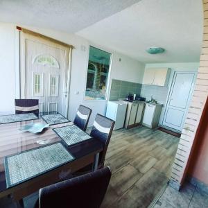 a kitchen with a table and chairs in a room at Villa Gjorgi in Ohrid