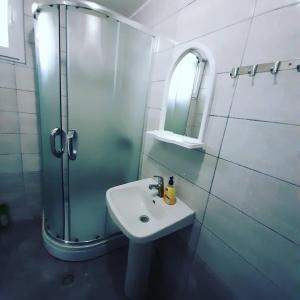 a bathroom with a sink and a shower at Villa Gjorgi in Ohrid