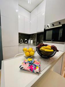 a kitchen with two bowls of fruit on a counter at Boutique apartman Dora Yung in Budva