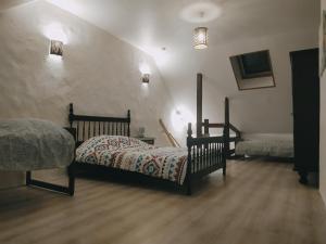 a bedroom with a bed and a staircase with lights at 35 min Disney - Paris - Family room at homestay with bathtub and dining - lounge area - secure parking - 5 people and 1 baby - duplex with independent entrance on 1rst floor at inhabitant's house in Coupru