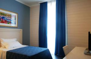 Postel nebo postele na pokoji v ubytování Hotel Palazzo Giancola