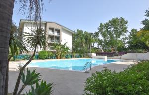 a swimming pool in front of a building at 3 Bedroom Lovely Apartment In Calatabiano in Calatabiano