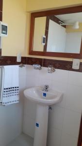 a bathroom with a sink and a mirror at LA KANTUTA in Comunidad Yumani