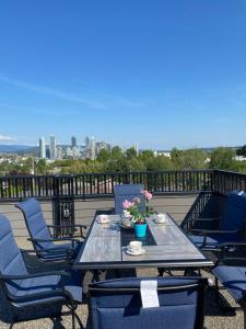 a table and chairs on a balcony with a view of the city at Six minutes to Rupert station in Vancouver