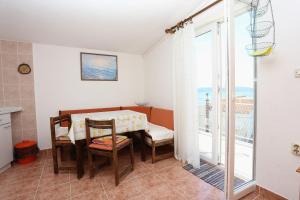 a dining room with a table and chairs and a balcony at Apartments with parking space Zivogosce - Porat, Makarska - 10032 in Živogošće +43 photos