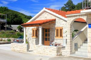 a small stone house with an orange roof at Seaside holiday house Grscica, Korcula - 10059 in Prizba