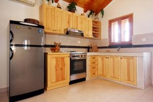 a kitchen with a stainless steel refrigerator and wooden cabinets at Seaside holiday house Grscica, Korcula - 10059 in Prizba