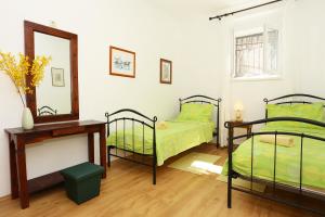 a bedroom with two bunk beds and a mirror at Apartments with WiFi Split - 10243 in Split