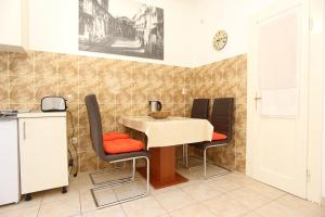 a dining room with a table and four chairs at Apartments with WiFi Split - 10243 in Split