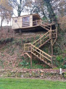 a tree house on the side of a hill at Moinho de Pedra Má in Arouca