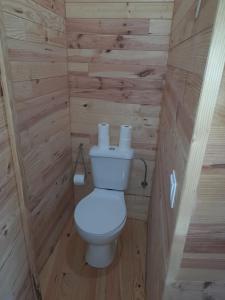 a bathroom with a toilet in a wooden cabin at Moinho de Pedra Má in Arouca