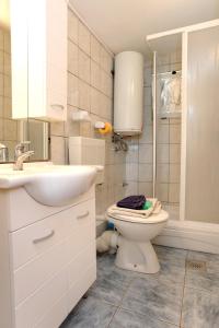 a bathroom with a toilet and a sink at Apartments by the sea Zuronja, Peljesac - 10123 in Brijesta