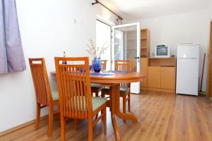 a kitchen and dining room with a table and chairs at Apartments by the sea Zuronja, Peljesac - 10123 in Brijesta