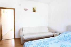 a white room with a bed and a mirror at Apartment Zuronja 10137b in Brijesta