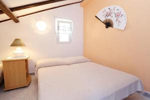 a bedroom with a bed and a clock on the wall at Apartments by the sea Zuljana, Peljesac - 10112 in Žuljana