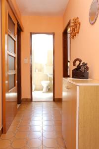 a hallway with a bathroom with a toilet and a sink at Apartment Zuljana 10112a in Žuljana