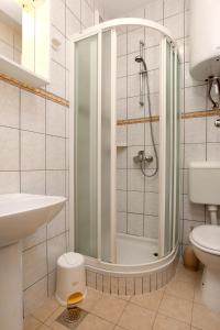 a bathroom with a shower and a toilet and a sink at Apartment Drace 10127c in Drače