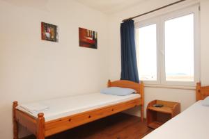 a bedroom with two beds and a window at Studio Orebic 10191f in Orebić