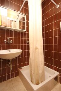 a bathroom with a sink and a shower curtain at Twin Room Orebic 10192a in Orebić