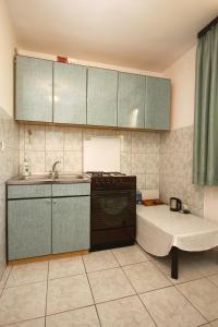 a kitchen with a sink and a tub in it at Apartments with a parking space Orebic, Peljesac - 10193 in Orebić