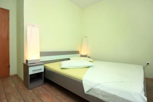 a bedroom with a white bed with a lamp on it at Apartments by the sea Kuciste - Perna, Peljesac - 10154 in Kučište