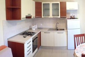 a kitchen with a sink and a stove top oven at Apartments with a parking space Lumbarda, Korcula - 9474 in Lumbarda